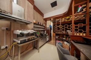 a kitchen with a stove and a counter with chairs at Premium Four Star Hotel by Blue Collection in Ras al Khaimah