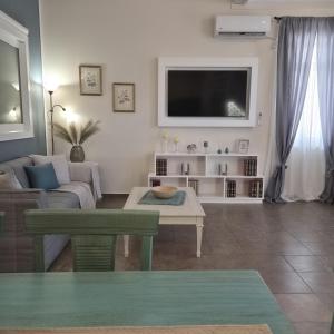 a living room with a couch and a tv at Petrino Guesthouse I Central Mytilini Stay in Pámfylla +66 photos