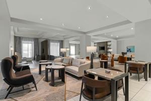 a living room with a couch and chairs and tables at Franklin Marriott Cool Springs in Franklin