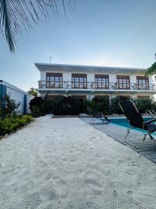 a house with a balcony and a swimming pool at Cheff Hotel Vianuel in Kendwa