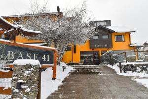 an orange house with a sign in the snow at Complejo Base 41 in San Carlos de Bariloche +91 photos