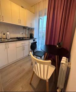 a kitchen with a table and two chairs and a table at City Center in Vanadzor