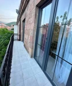 a balcony with large glass doors on a building at City Center in Vanadzor