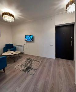 a living room with a blue couch and a table at City Center in Vanadzor