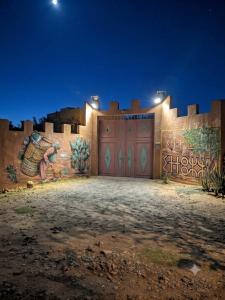 a wall with a garage with a painting on it at Quiet house with pool in Aïn Harrouda