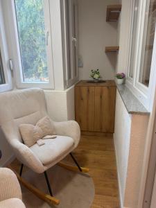 a living room with a chair and a counter at Ines Apartment in Sarajevo +8 photos