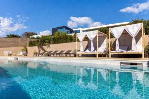 a hotel swimming pool with chairs and a marquee at Designer Haus - Pool - Sea Views - 7BR - Sleeps 14 in Brighton & Hove