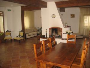 a living room with a table and a fireplace at Pension Irina in Arefu
