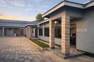a rendering of a house with a driveway at Chaniche Executive Lodge in Ndola