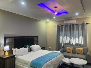a bedroom with a bed and a purple ceiling at Chaniche Executive Lodge in Ndola