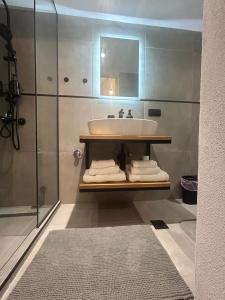 a bathroom with a sink and a mirror at The Square Point in Komotini +2 photos
