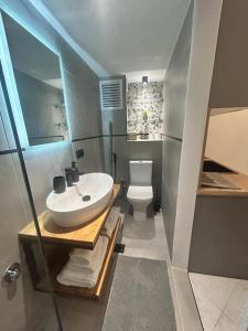 a bathroom with a sink and a toilet at The Square Point in Komotini