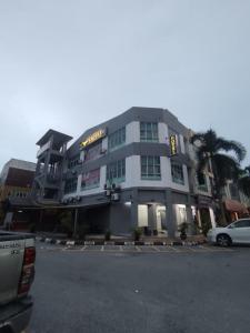 a building with a car parked in front of it at Hotel Empire Banting in Banting