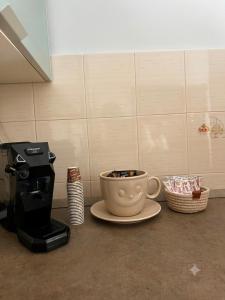a coffee maker and a cup of coffee on a counter at Appartamento Mina' in Adrano