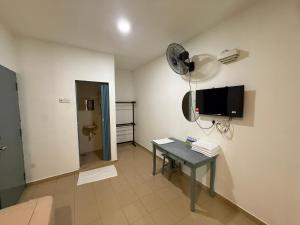 a room with a table and a tv on the wall at Hotel Empire Banting in Banting +21 photos