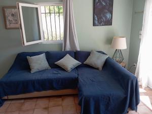 a blue couch in a room with a window at La maison multicolore in Salon-de-Provence +15 photos