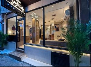 a store front with a potted plant in the window at فندق وفادة الزهراء in Baghdād