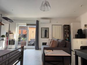 a living room with a couch and a table at The Hideaway - Secluded Studio Annexe in Cambourne