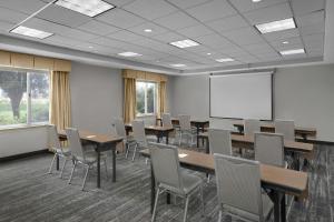 a conference room with tables and chairs and a whiteboard at TownePlace Suites Des Moines Urbandale in Johnston +103 photos