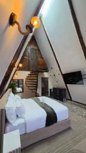 a bedroom with a large bed in a attic at Mvubu Falls Lodge in Lobamba