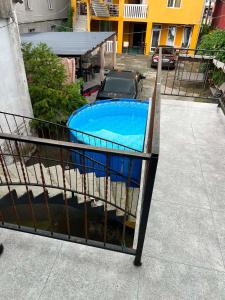 a small swimming pool in a yard with a building at Blue wave in Itʼkhvisi