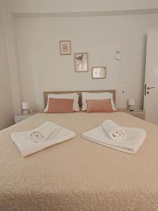 a bedroom with a bed with two white towels on it at Vivari apartment in Vivari