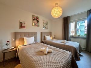 a hotel room with two beds with towels on them at Prinshöjden Apartments - Katrineholm Central in Katrineholm