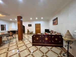 a living room with a couch and a piano at Quiet house with pool in Aïn Harrouda