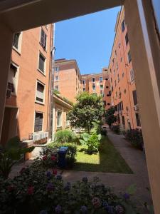 a view of a courtyard with buildings and flowers at Residence Emporium in Rome