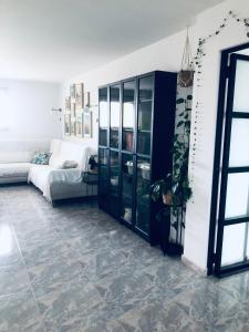 a living room with a black cabinet and a couch at Apartamento Conroibo in O Grove