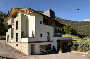 a house in the middle of a mountain at DaSte' ex Villa Ruggero in Campitello di Fassa