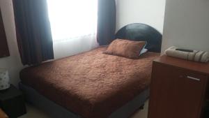 a bedroom with a bed with a pillow on it at Habitaciones Ciudad de la Luna Chia in Chía +42 photos