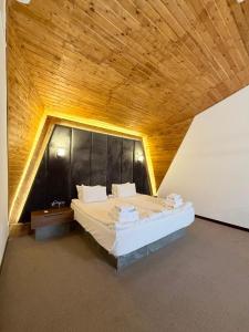 a bedroom with a large bed with a wooden ceiling at Lastiver Resort in Yenokavan +76 photos
