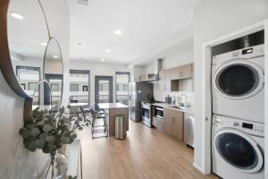 a kitchen with a washer and dryer in a house at Illume 303 in Nashville