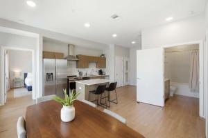 a kitchen and living room with a table and chairs at Illume 303 in Nashville