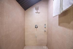 a bathroom with a shower with a glass door at Treebo Five Elements with Swimming Pool in Lonavala +38 photos