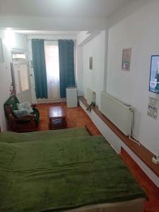 a living room with two beds and a couch at Pensiunea Pitaru in Calafat
