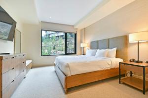 a bedroom with a large bed and a window at Lift Park City Condominiums by Vail Resorts in Park City +205 photos