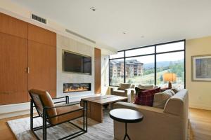 a living room with a couch and a fireplace at Lift Park City Condominiums by Vail Resorts in Park City