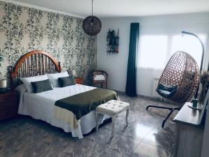 a bedroom with a bed and a chair at Apartamento Conroibo in O Grove +40 photos