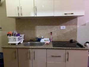 a kitchen counter with a sink and a stove at Pool view studio apartment, Aqua View Resort, North coast in El Alamein