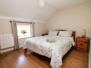 a bedroom with a large bed and a window at Pen Y Grisiau in Mold