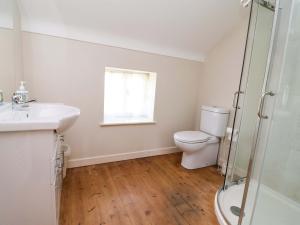 a bathroom with a toilet and a sink and a shower at Pen Y Grisiau in Mold +24 photos