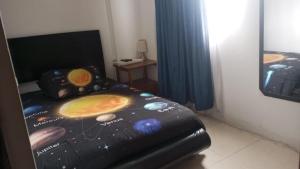a bedroom with a bed with an image of the solar system at Habitaciones Ciudad de la Luna Chia in Chía