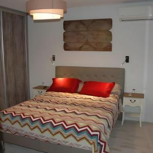 a bedroom with a bed with two red pillows at Cabesthotes in Cabestany +27 photos