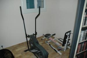 a room with a gym with a treadmill and a chair at Cabesthotes in Cabestany
