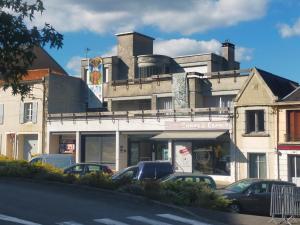 a building with cars parked in front of it at les terrasses du Thouet in Parthenay