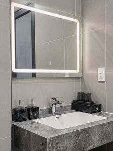 a bathroom with a sink and a mirror at Tulip Building in Ðông Khê