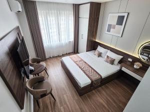 a hotel room with a bed and a table and chairs at Tulip Building in Ðông Khê