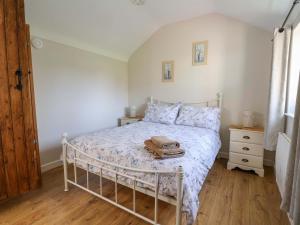 a bedroom with a bed with a purse on it at Ty Haf in Mold